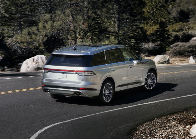 A 2023 Lincoln Aviator® Grand Touring model is shown being driven on a tight turn of a mountain road | Magic City Lincoln in Roanoke VA